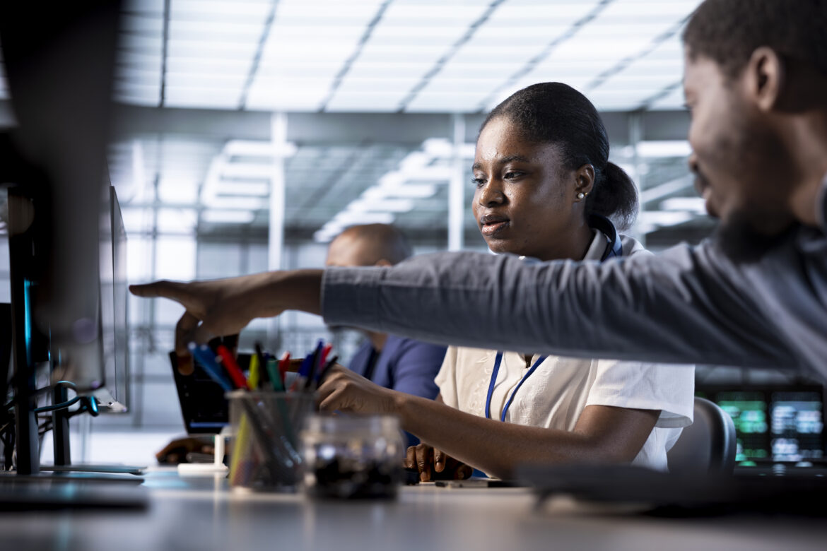 Nigerian tech professionals collaborating on AI training jobs in Nigeria, showcasing teamwork and innovation in a modern workspace.