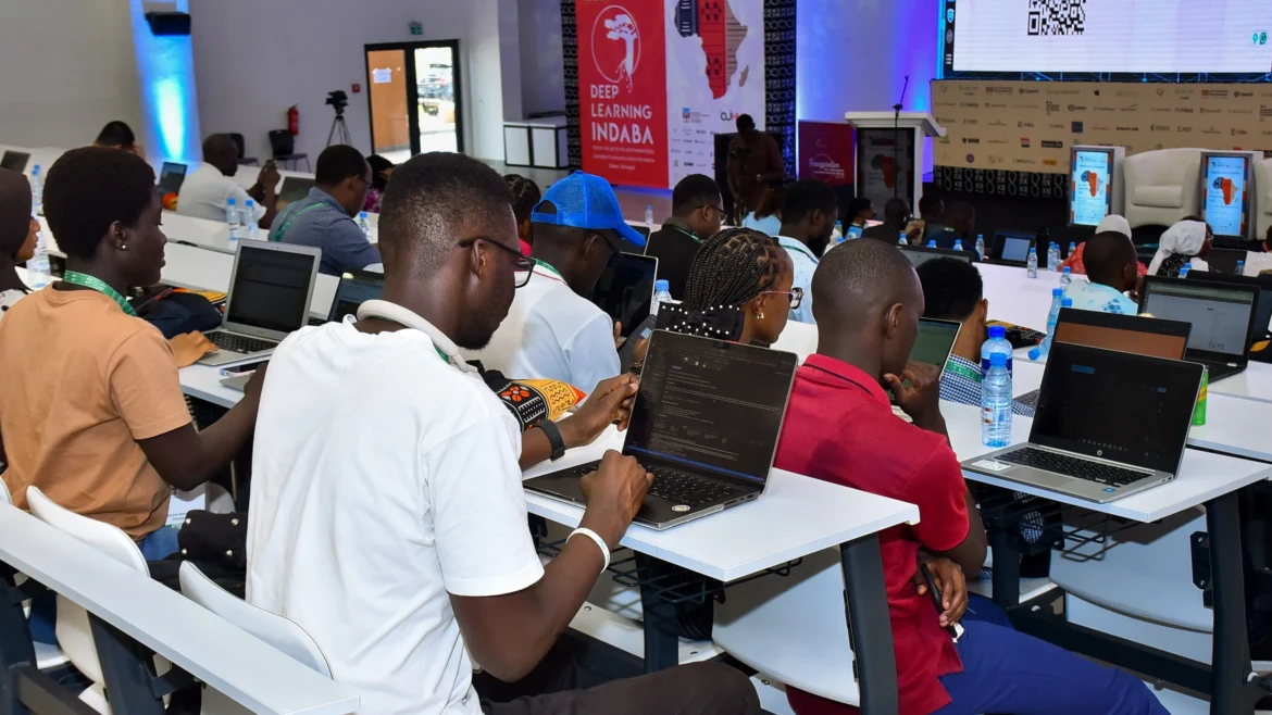 African AI researchers and developers working on laptops at a machine learning conference, illustrating AI innovation in Africa and its impact on jobs and skills
